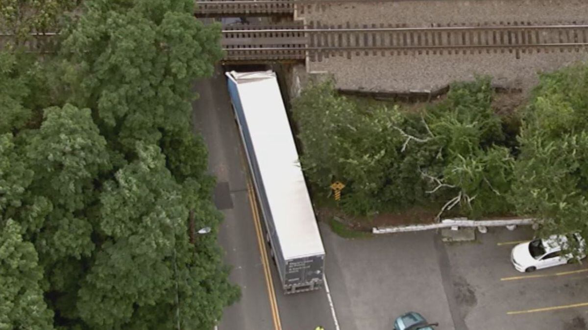 Amazon truck hits bridge, gets stuck in roadway